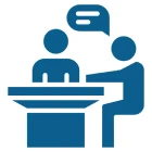 Two people talking at a table icon.